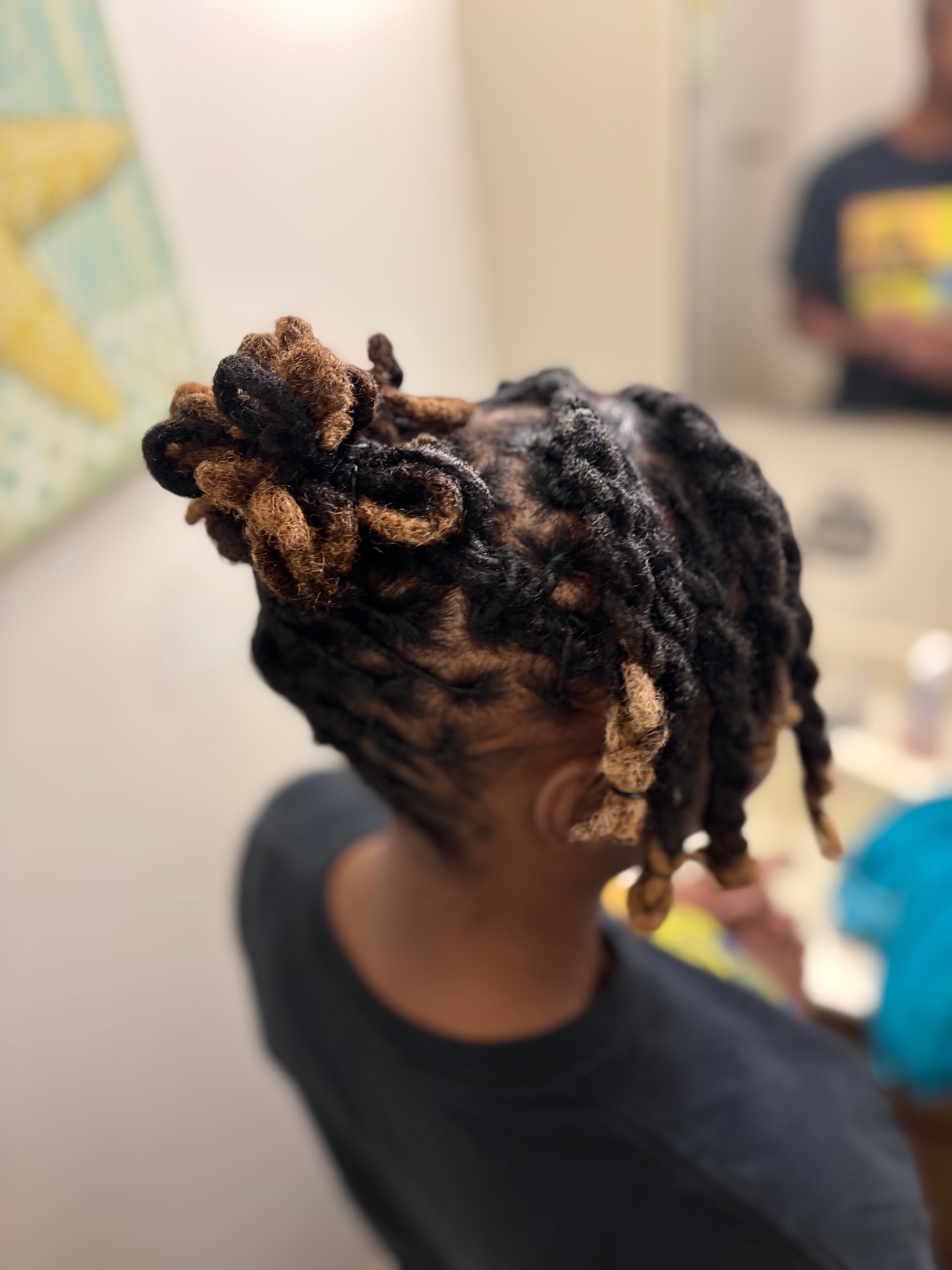 Natural hair neatly sectioned into two-strand twists with highlighted ends