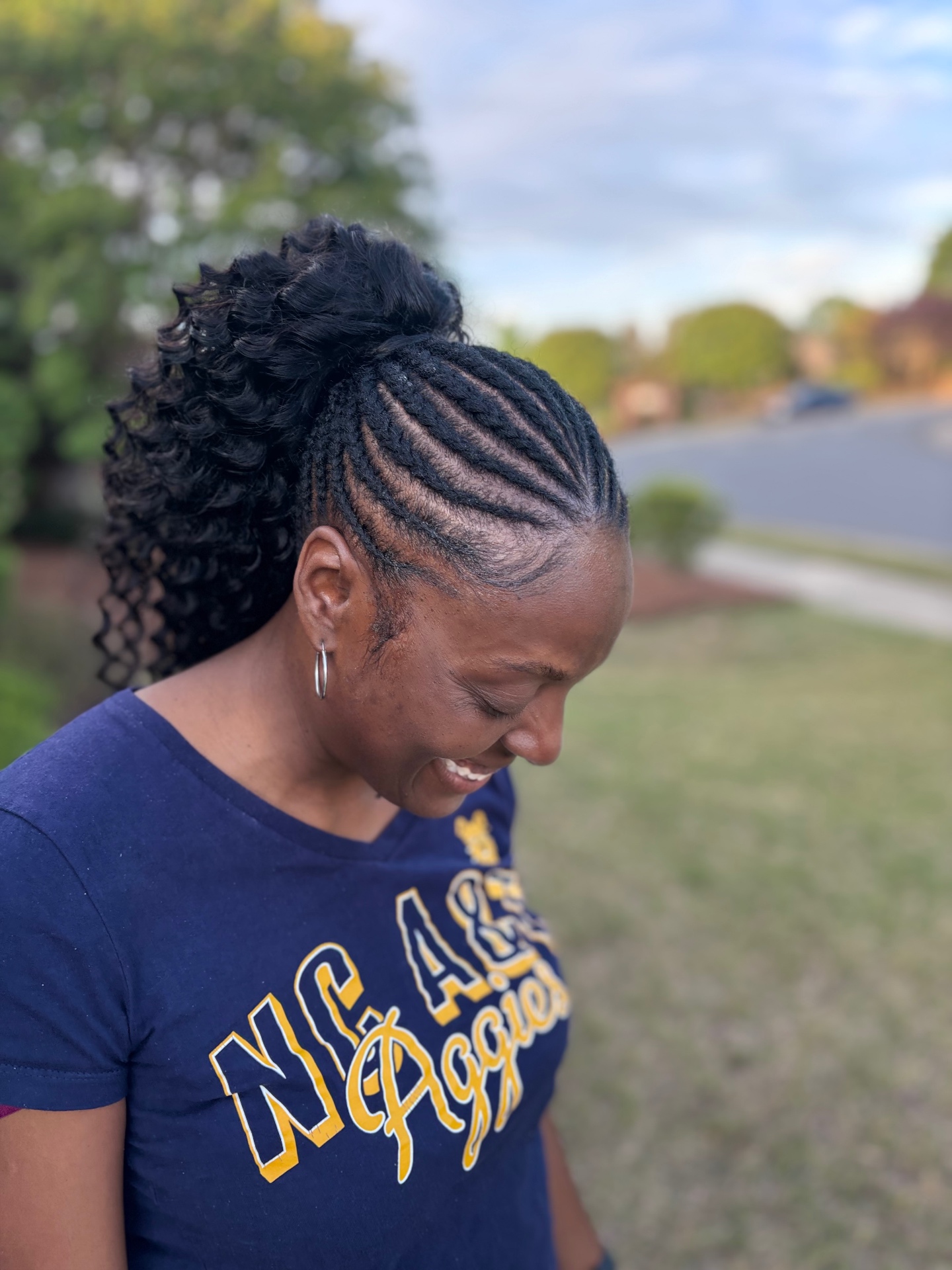 Braided curly ponytail with neat cornrows and a full curly finish