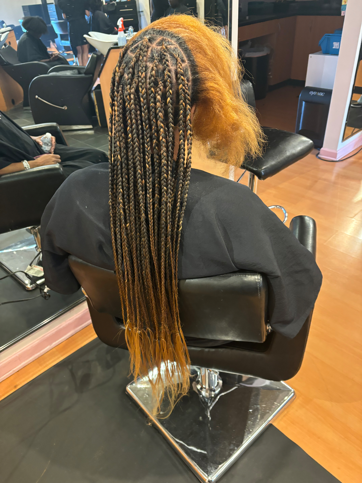 Protective braid installation in progress for a salon client