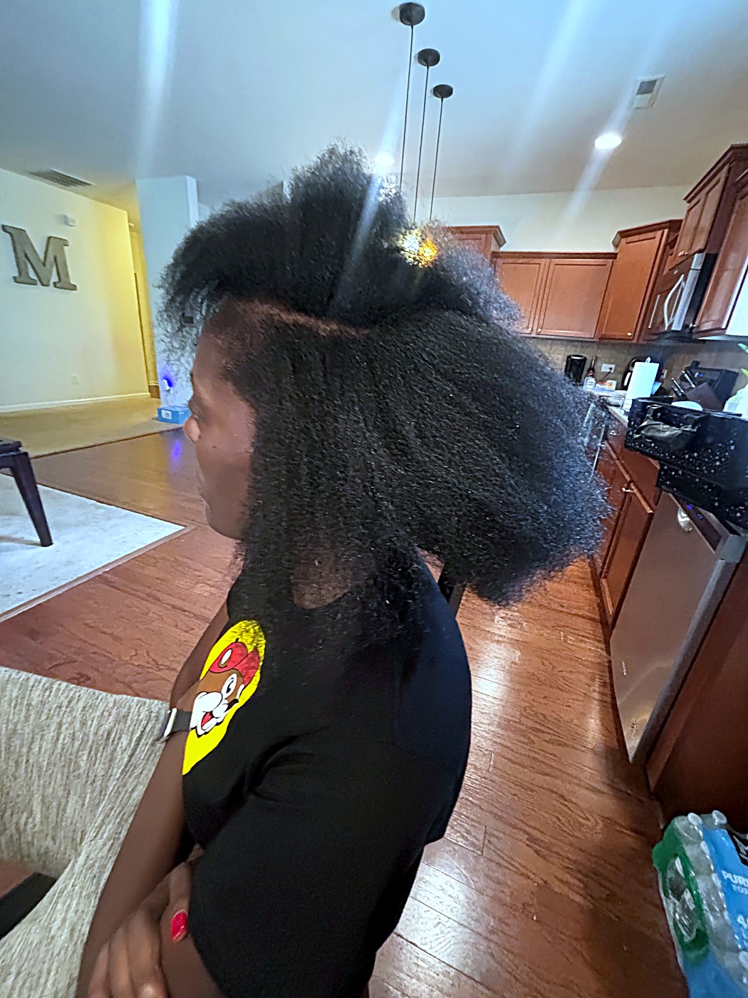 Close side view of natural hair texture, showing fine strands sectioned for assessment