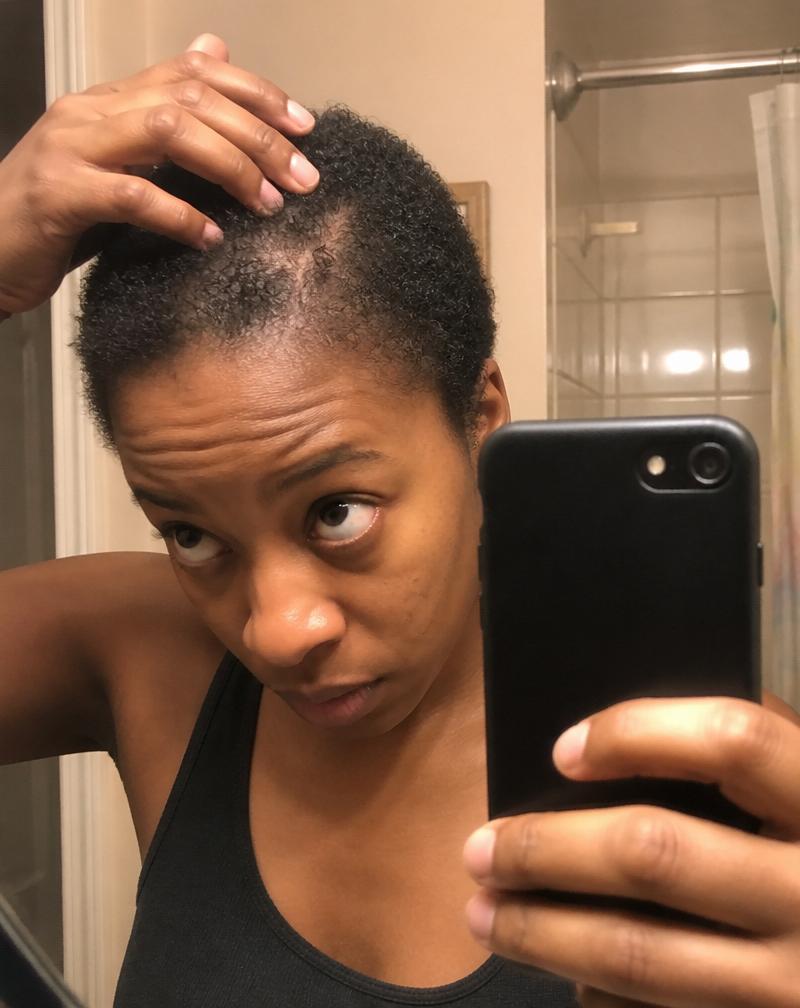 A Black woman scanning her fine natural hair with My Crown AI